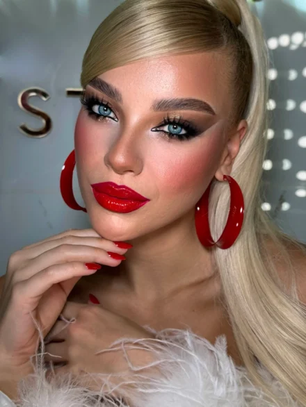Classic Hollywood glam makeup with red lips and large hoop earrings, by Anna Balantinou