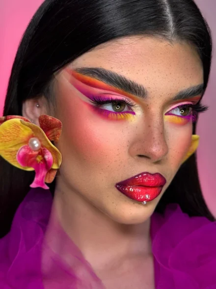 Bold pink and orange graphic eye makeup with orchid flower, by makeup artist Anna Balantinou